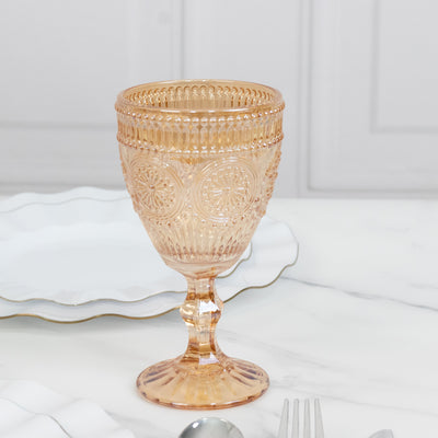 Vintage pink glass goblet with intricate patterns
