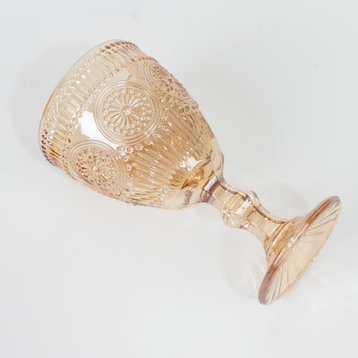 Rose glass goblet with intricate design and textured surface