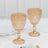 Elegant pink vintage goblets on a marble table setting.