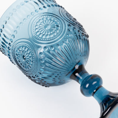 Blue decorative glass goblet with intricate patterns and embossed details.