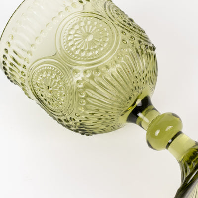 Green decorative glass goblet with intricate texture and design.
