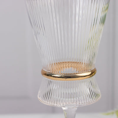Elegant ribbed glass vase with gold accent.