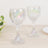 Elegant iridescent wine glasses on a wooden table