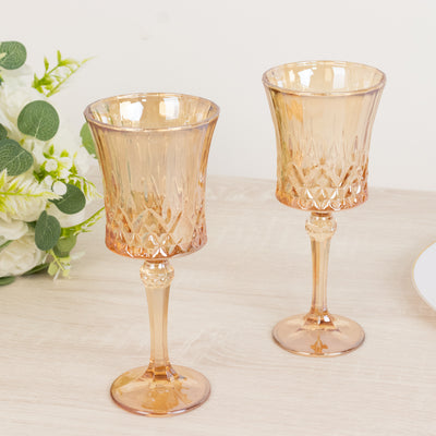 Elegant set of two amber glass goblets on a wooden table.