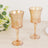 Elegant set of two amber glass goblets on a wooden table.