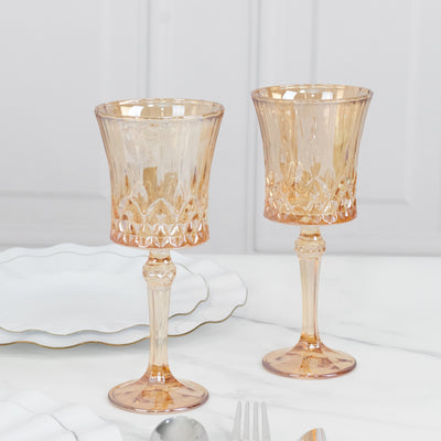 Elegant pink glass goblets with intricate design, perfect for dining.