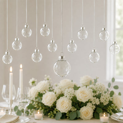 Elegant wedding table with white roses, candles, and hanging glass ornaments