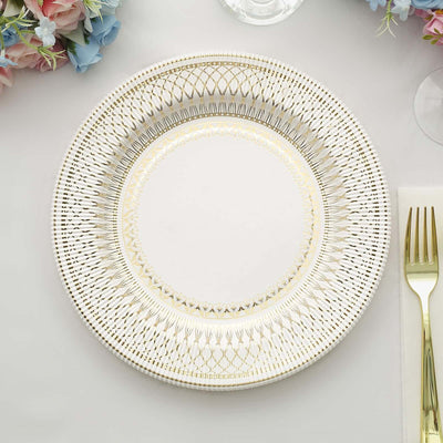 Elegant white plate with intricate gold detailing, centered on a table setting.