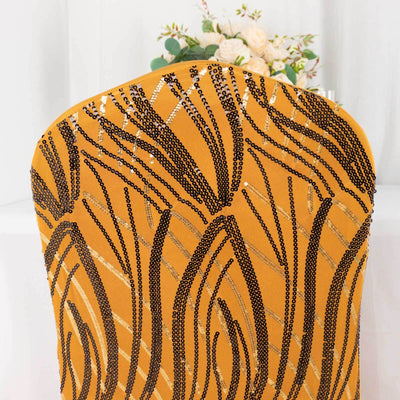 Gold and black patterned chair back with sequins against a blurred background.