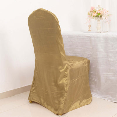 Gold chair cover draped on a chair at a table setting.