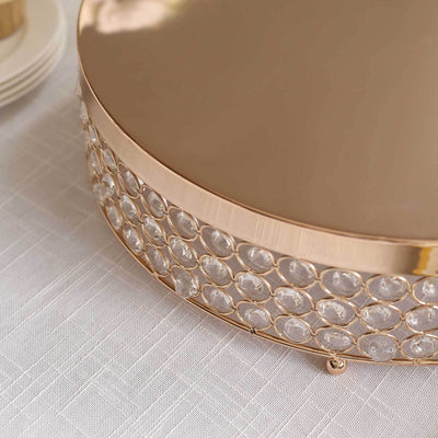 Elegant gold and crystal cake stand with a smooth top and decorative base.