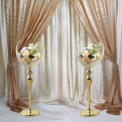 Elegant floral centerpieces on gold stands, perfect for events or weddings.