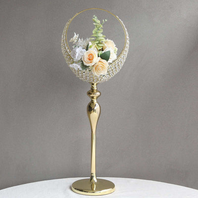 Elegant gold flower vase with artificial roses and greenery.