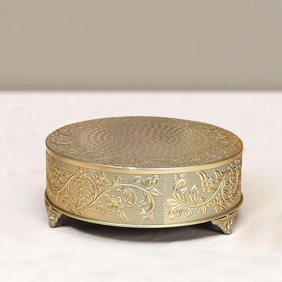 Decorative gold cake stand with intricate floral design.