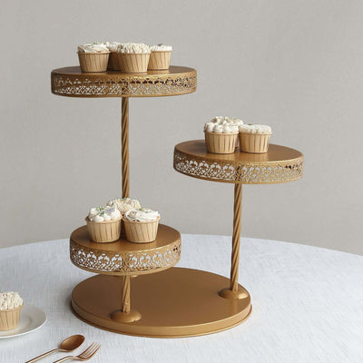 Gold cupcake stand with decorated cupcakes on a table.