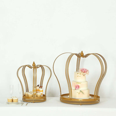 Gold crown cake stands with dessert display, featuring a floral cake and treats.