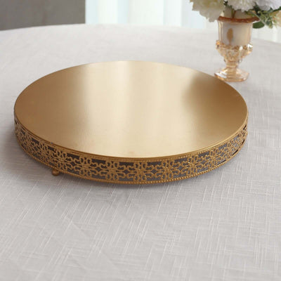 Gold decorative cake stand with intricate lace design.