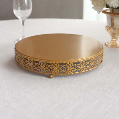 Gold decorative cake stand with intricate lace design.