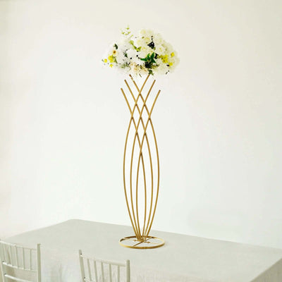 Gold abstract flower vase with white blooms on a table