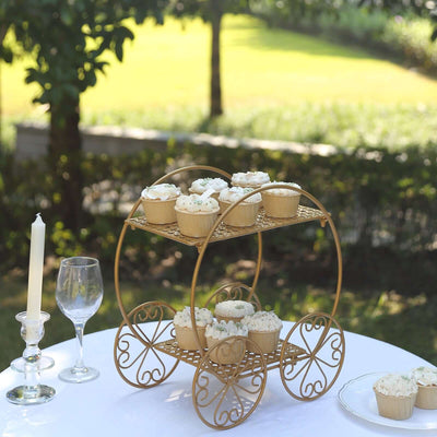 Gold cupcake stand with decorated cupcakes in a garden setting.