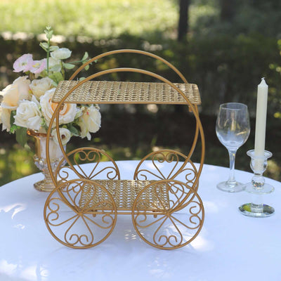 Gold decorative cart with intricate design, surrounded by flowers and glassware.
