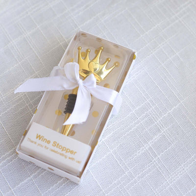Gold crown wine stopper in elegant packaging with ribbon.