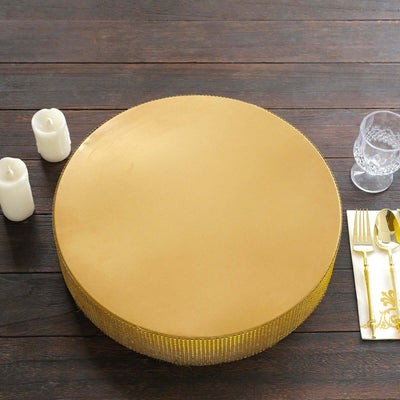 Gold round cake stand with beaded edge, elegantly displayed on a wooden table.
