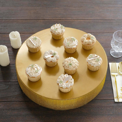 Assorted decorated cupcakes on a gold cake stand.