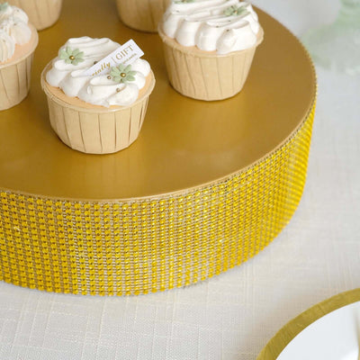 Cupcakes on a golden cake stand with decorative elements.