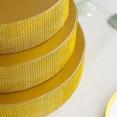 Yellow decorative cake stands in stacked arrangement.
