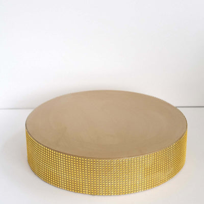 Round wooden cake stand with a gold mesh design.