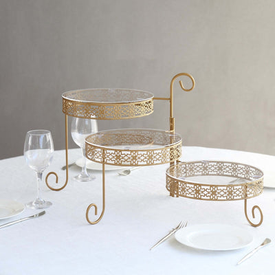 Elegant three-tiered dessert stand with gold metal and glass, perfect for events.