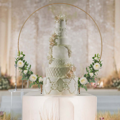 Elegant multi-tier wedding cake adorned with flowers and greenery.