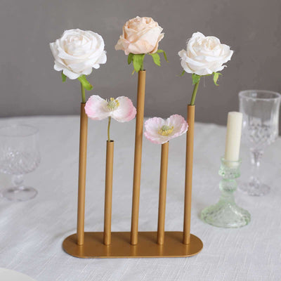 Gold flower vase with artificial roses and poppies on a table setting.