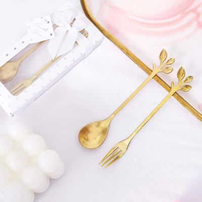 Gold fork and spoon set with leaf design, elegantly packaged in a gift box.