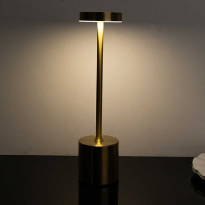 Modern gold table lamp with a sleek design and soft illumination.