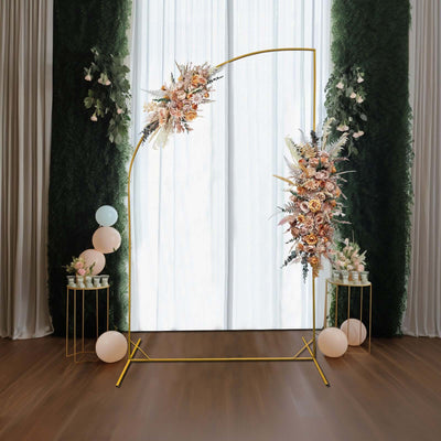 Elegant floral arch backdrop for events with soft drapes and decorative accents.