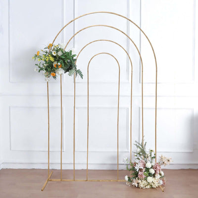 Gold arch backdrop with floral arrangements for events and photography.