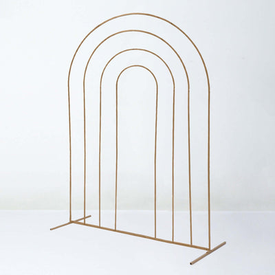 Gold metal arch display stand on a plain background.