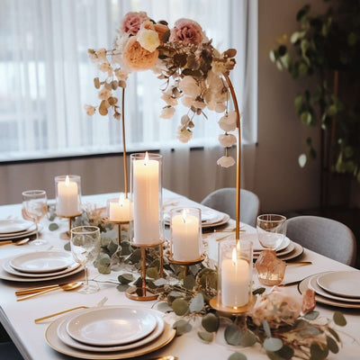 Elegant table setting with candles and floral decor in a modern dining room.