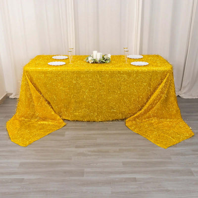 Yellow tablecloth with fringed texture, elegantly draped on a table.