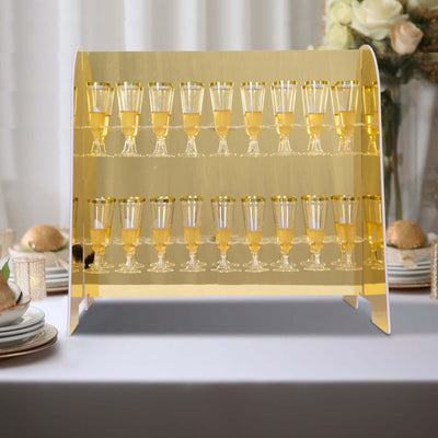 Golden champagne tower display with clear glasses filled with bubbly.