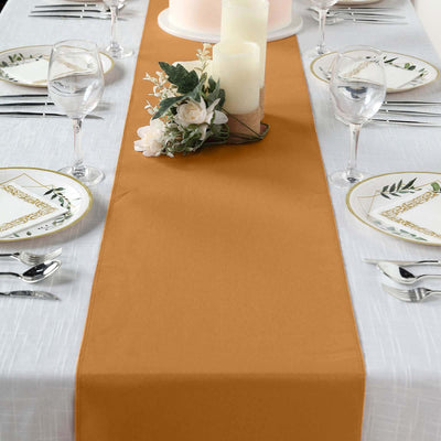 Table runner in warm amber color on elegantly set dining table.