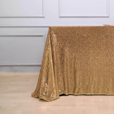 Gold sequin tablecloth draping elegantly on a table.