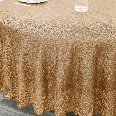 Gold tablecloth with textured design on a round table.