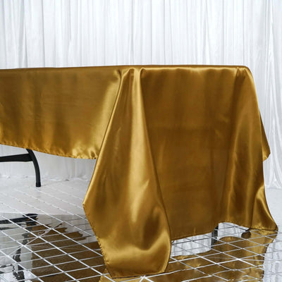Gold satin tablecloth draped elegantly over a table.
