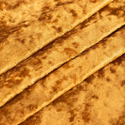 Soft golden velvet fabric with rich texture and depth.