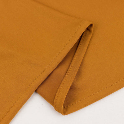 Brown fabric swatch showcasing smooth texture and fold detail.
