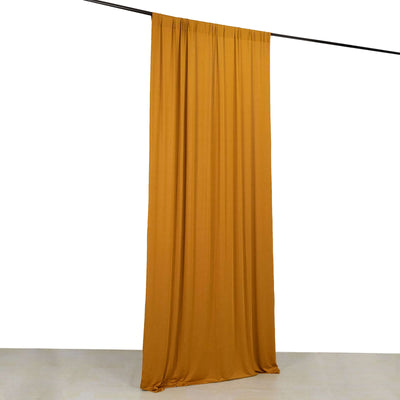 Mustard yellow fabric curtain hanging on a rod against a white background