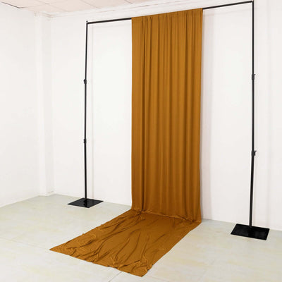 Brown fabric backdrop draped from a stand in a studio setting.